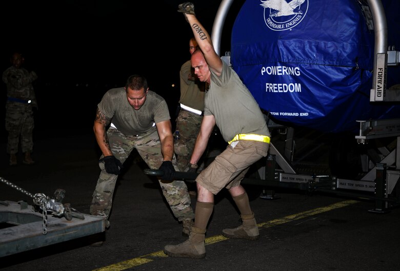 Staff Sgt. Christopher Vechinsky (left), 380th Expeditionary Logistics Readiness Squadron cargo team chief, and Tech. Sgt. Ryan Gilroy, 380th LRS cargo noncommissioned officer in charge, connect an F-35A Lighting II engine to a tow truck, August 26, 2020, Al Dhafra Air Base, United Arab Emirates.
