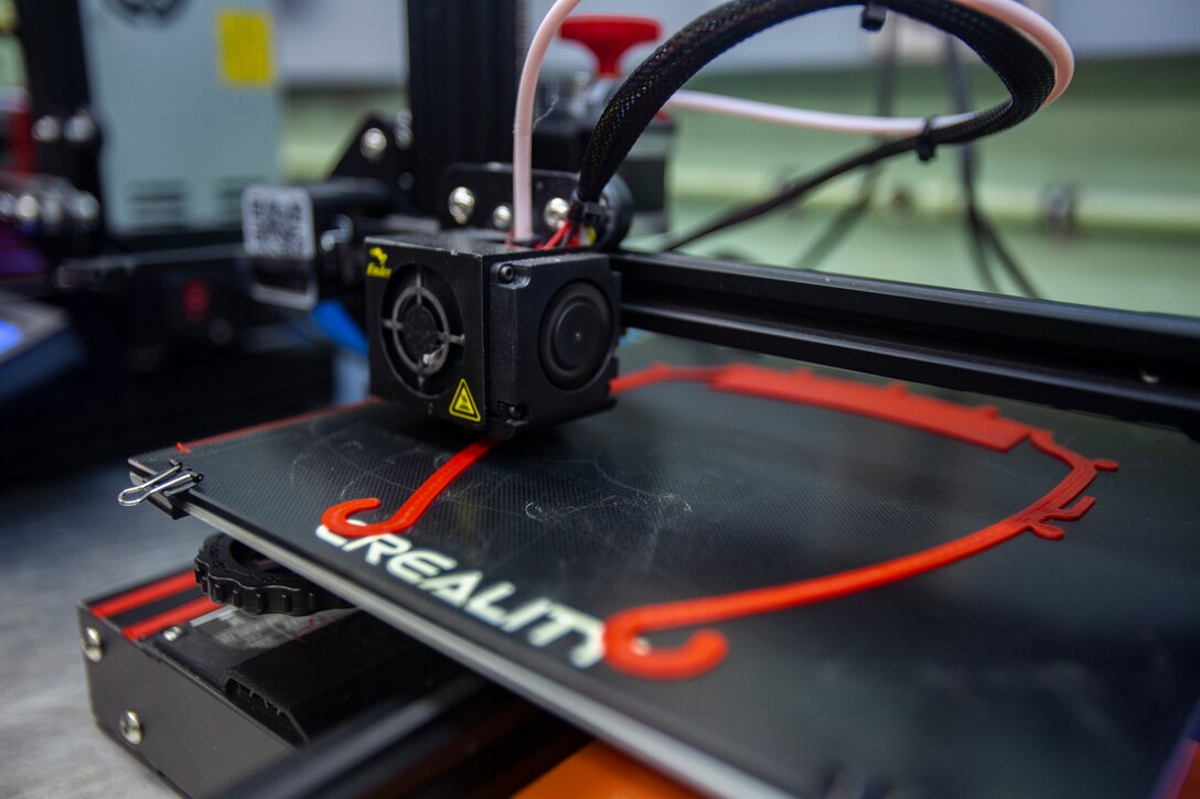 A 3D printer belonging to Marine Air Logistics Squadron 36 prints the frame for a face shield on MCAS Futenma, Okinawa, Japan, April 7, 2020. The Marines of MALS-36 are working to produce mask frames and face shields for use in the fight against COVID-19. (U.S. Marine Corps photo by Lance Cpl. Ethan M. LeBlanc)