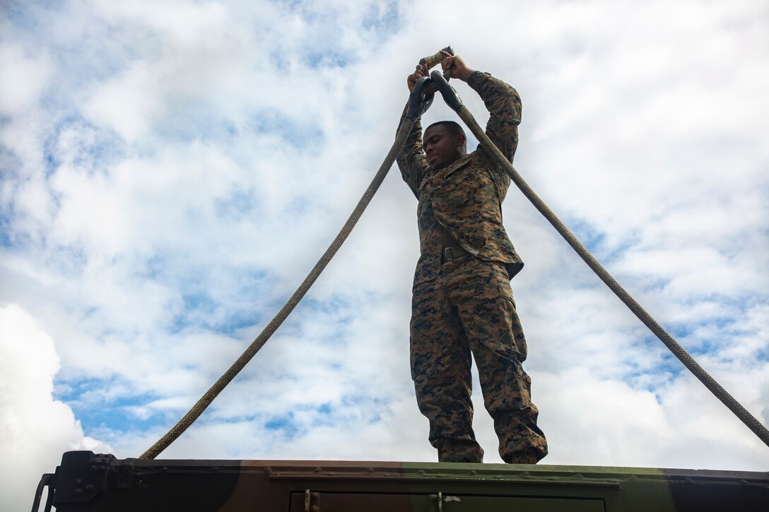 U.S. Marine Cpl. James Thompson with Combat Logistics Battalion 4, 3rd Marine Logistics Group, prepares a vehicle for an external lift exercise at Okinawa, Japan, Sept. 22, 2020. Thompson helps to prepare the Direct Air Support Center’s Communication Vehicle for an external lift to improve their expeditionary capabilities. (U.S. Marine Corps photo by Lance Cpl. Dalton J. Payne)