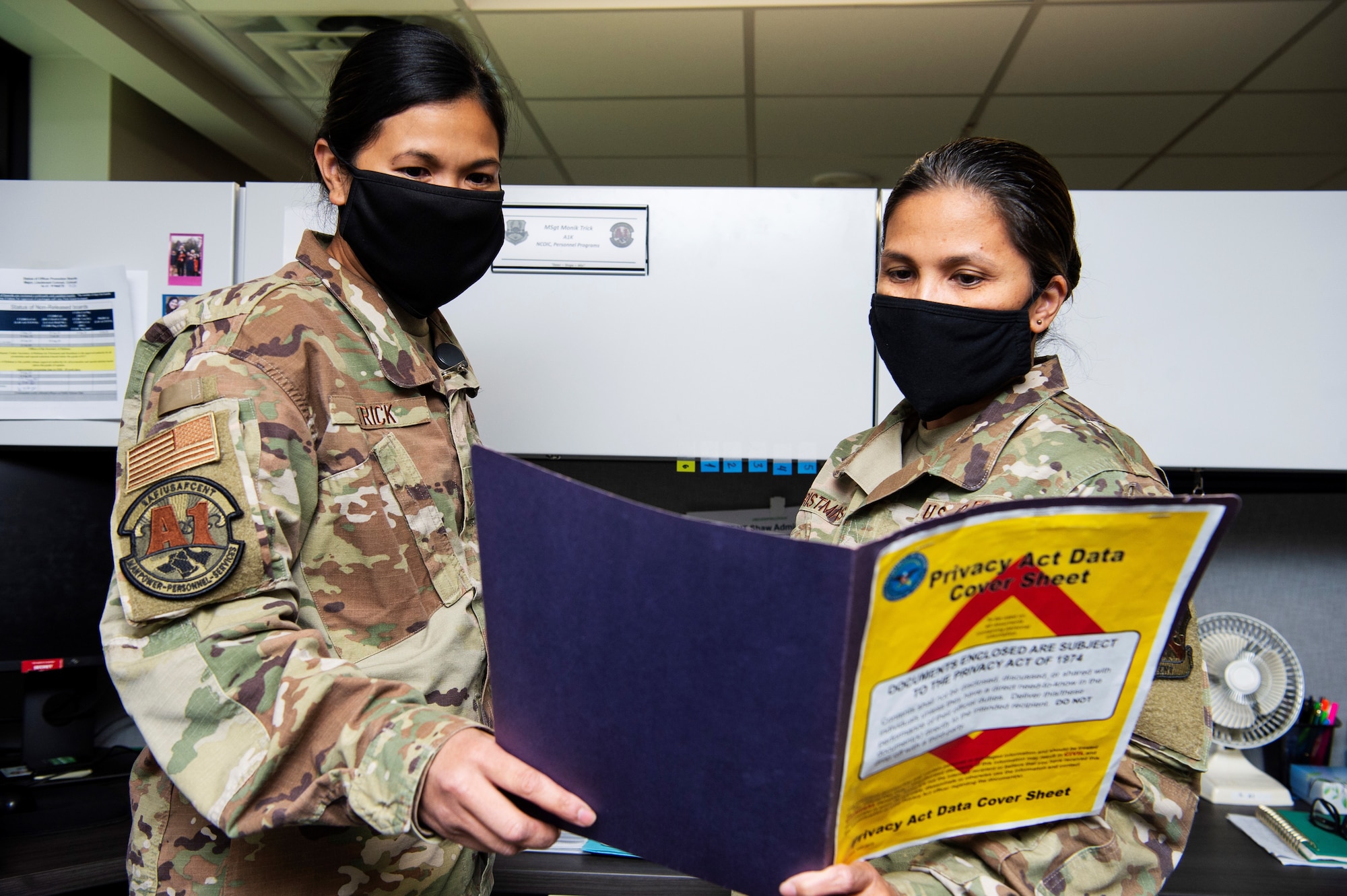 U.S. Air National Guard Tech. Sgt. Marsha Christmas, right, 9th Air Force (Air Forces Central) personnel division, reviews a document with U.S. Air Force Master Sgt. Monik Trick, 9th AF (AFCENT) personnel programs superintendent, at Shaw Air Force Base, South Carolina, Nov. 2, 2020.