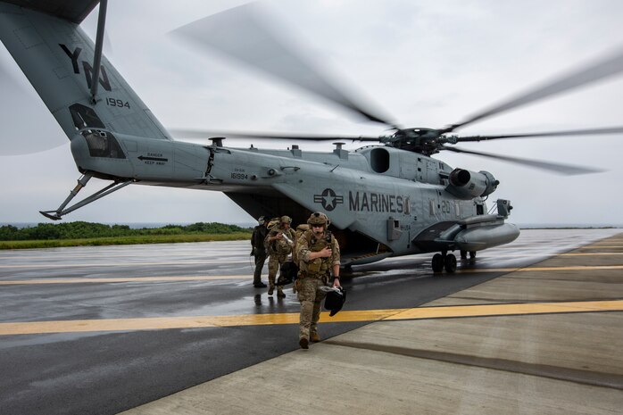 U.S. Airmen with Special Operations Forces Medical Element, 18th Wing disembark from a CH-53E Super Stallion helicopter with Marine Heavy Helicopter Squadron 361 (HMH-361) prior to conducting a simulated casualty evacuation drill at Ie Shima, Okinawa, Japan, Oct. 8, 2020. The Airmen conducted various operations on casualties until transported to the U.S. Naval Hospital Okinawa, in support of exercise Noble Fury 21. (U.S. Marine Corps photo by Cpl. Ethan M. LeBlanc)
