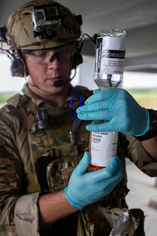 A U.S. Airman with Special Operations Forces Medical Element, 18th Wing, prepares freeze-dried plasma during a simulated casualty evacuation drill at Ie Shima, Okinawa, Japan, Oct. 8, 2020. The Airmen conducted various operations on casualties until transported to the U.S. Naval Hospital Okinawa, in support of exercise Noble Fury 21. (U.S. Marine Corps photo by Cpl. Ethan M. LeBlanc)