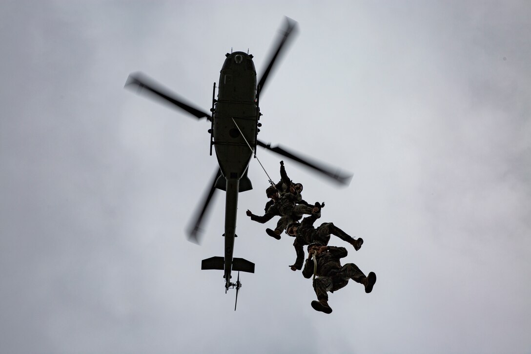 U.S. Marines with III Marine Expeditionary Force (III MEF), Expeditionary Operation Training Group (EOTG) with Marine Light Attack Helicopter Squadron 469 (HMLA-469), conduct special patrol insertion/extraction and helicopter rappel training at Camp Hansen, Okinawa, Japan, Oct. 23, 2020. EOTG trains Marines before being attached to Marine Expeditionary Units, where they will conduct operations using these techniques. (U.S. Marine Corps photo by Lance Cpl. Dalton J. Payne)