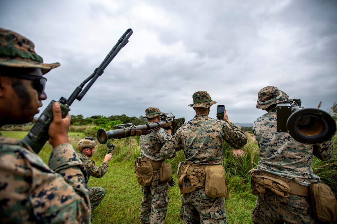 U.S. Marines with 3rd Low Altitude Air Defense Battalion (LAAD) use a Tracking Head Trainer (THT), a training weapon system used by LAAD units to gain proficiency with the stinger missile system without having to utilize live ammunitions, to track the movements of a CH-53E Super Stallion with Marine Heavy Helicopter Squadron 361 (HMH-361) during a combined Ground Threat Reaction (GTR) training event at the northern training area, Okinawa, Japan, Oct. 23, 2020. 3rd LAAD and HMH-361 conducted the training event to improve their skills and proficiency with both aerial maneuvers and the THT weapon system. (U.S. Marine Corps photo by Cpl. Ethan M. LeBlanc)