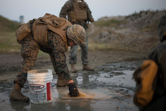 U.S Marines with Marine Wing Support Squadron 171 repair damage to a concrete slab that simulates damage to an airfield during Exercise Active Shield aboard Marine Corps Air Station (MCAS) Iwakuni, Japan, Oct. 29, 2020. Active Shield is an annual bilateral exercise partnering U.S. and Japanese forces for the protection and defense of MCAS Iwakuni and other assets in the region in order to sustain military operations in support of the U.S.-Japan Alliance. (U.S. Marine Corps photo by Lance Cpl. Bryant Rodriguez)