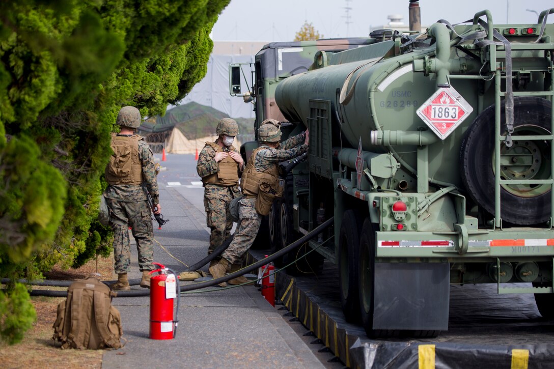 U.S. Marines with Marine Wing Support Squadron (MWSS) 171 prepare a forward arming and refueling point (FARP) in support of Exercise Active Shield aboard Marine Corps Air Station (MCAS) Iwakuni, Japan, Oct. 28, 2020. The Marines of MWSS-171 converted the parade field of MCAS Iwakuni into a landing zone and FARP to support sustained aviation operations. Active Shield is an annual bilateral exercise partnering U.S and Japanese forces for the protection and defense of MCAS Iwakuni and other assets in the region in order to sustain military operations in support of the U.S.-Japan Alliance.  (U.S. Marine Corps photo by Lance Cpl. Tyler Harmon)