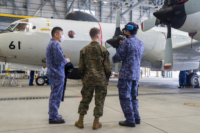 A U.S. Marine with Marine Aerial Refueler Transport Squadron 152 speaks with Japan Maritime Self-Defense Force personnel with Maintenance and Supply Squadron 31 during Exercise Keen Sword 2021 at Marine Corps Air Station Iwakuni, Japan, Nov. 2, 2020. Keen Sword is a series of joint/bilateral training exercises designed to increase combat readiness and interoperability of Japan Self-Defense Force and U.S. forces. (U.S. Marine Corps photo by Lance Cpl. Tyler Harmon)