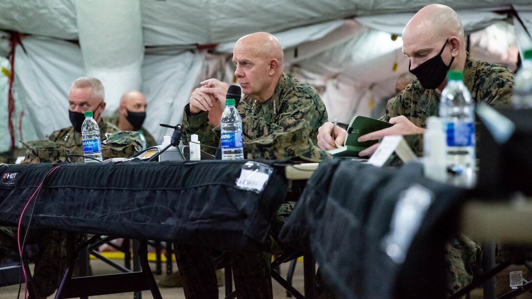 U.S. Marine Corps Gen. David H. Berger, 38th commandant of the Marine Corps, and Sgt. Maj. of the Marine Corps Troy E. Black, attend a 1st Marine Aircraft Wing (MAW) operational brief during Exercise Driven Thermite 21 at Marine Corps Air Station Futenma, Okinawa, Japan, Nov. 16, 2020. This exercise ensures that 1st Marine Aircraft Wing (MAW) personnel are ready to plan and execute air operations in the Indo-Pacific by operating in a simulated environment. (U.S. Marine Corps photo by Capt. Karen Jensen)