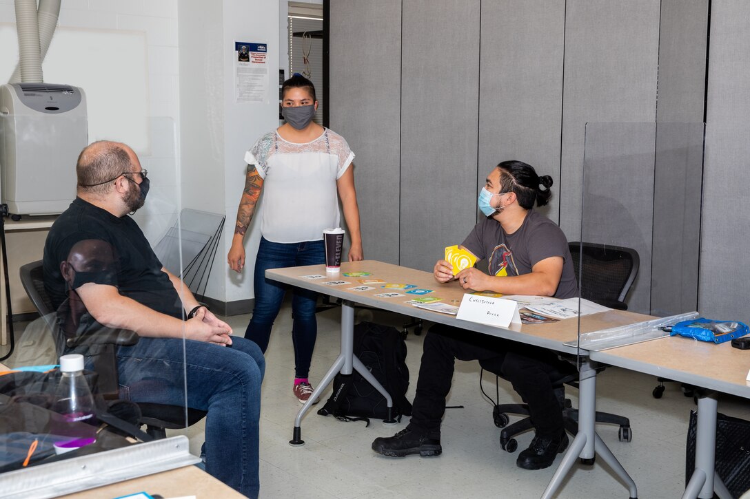 Leslie Mok answers questions from students during a training seminar.