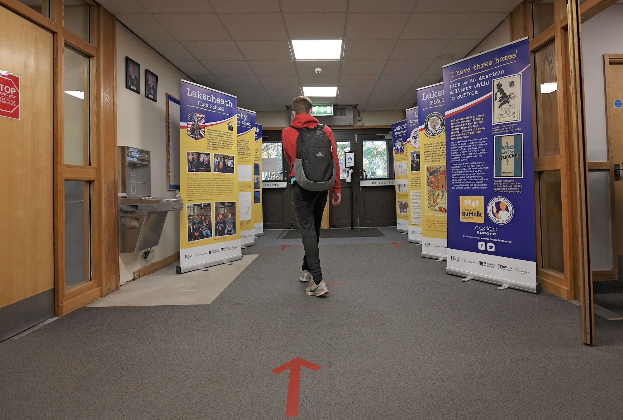 A military child observes host nation partnership displays at the Lakenheath High School, Royal Air Force Lakenheath, England, Nov. 23, 2020. The displays are a part of a project, “I have three homes," that aims to connect local nationals with U.S. military children attending schools at RAFs Lakenheath and Feltwell. (U.S. Air Force photo by Senior Airman Shanice Ship)