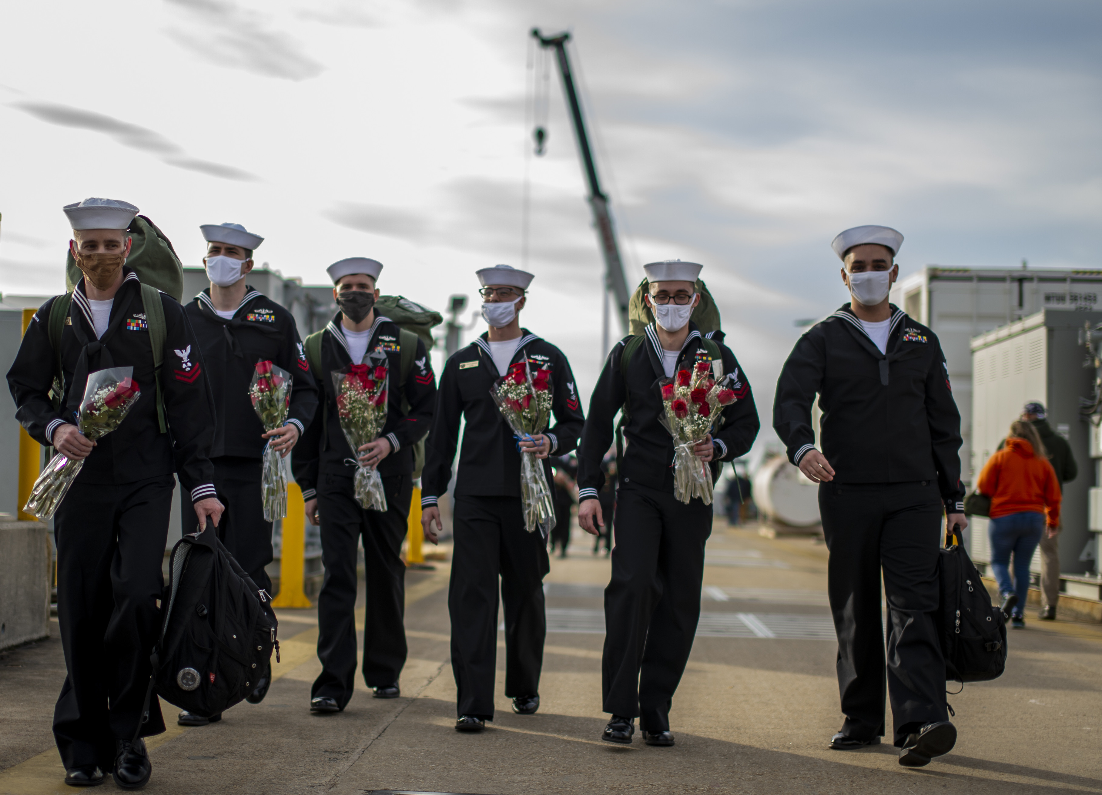 Sailors assigned to the Virginia-class fast-attack submarine USS John Warner (SSN 785) prepare to greet family members at Naval Station Norfolk, Nov. 25, 2020.