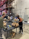 Jennifer Flores, NSA-Texas chief of Policy, and Alicia Butler, NSA-Texas Higher Ed lead, help fill boxes.