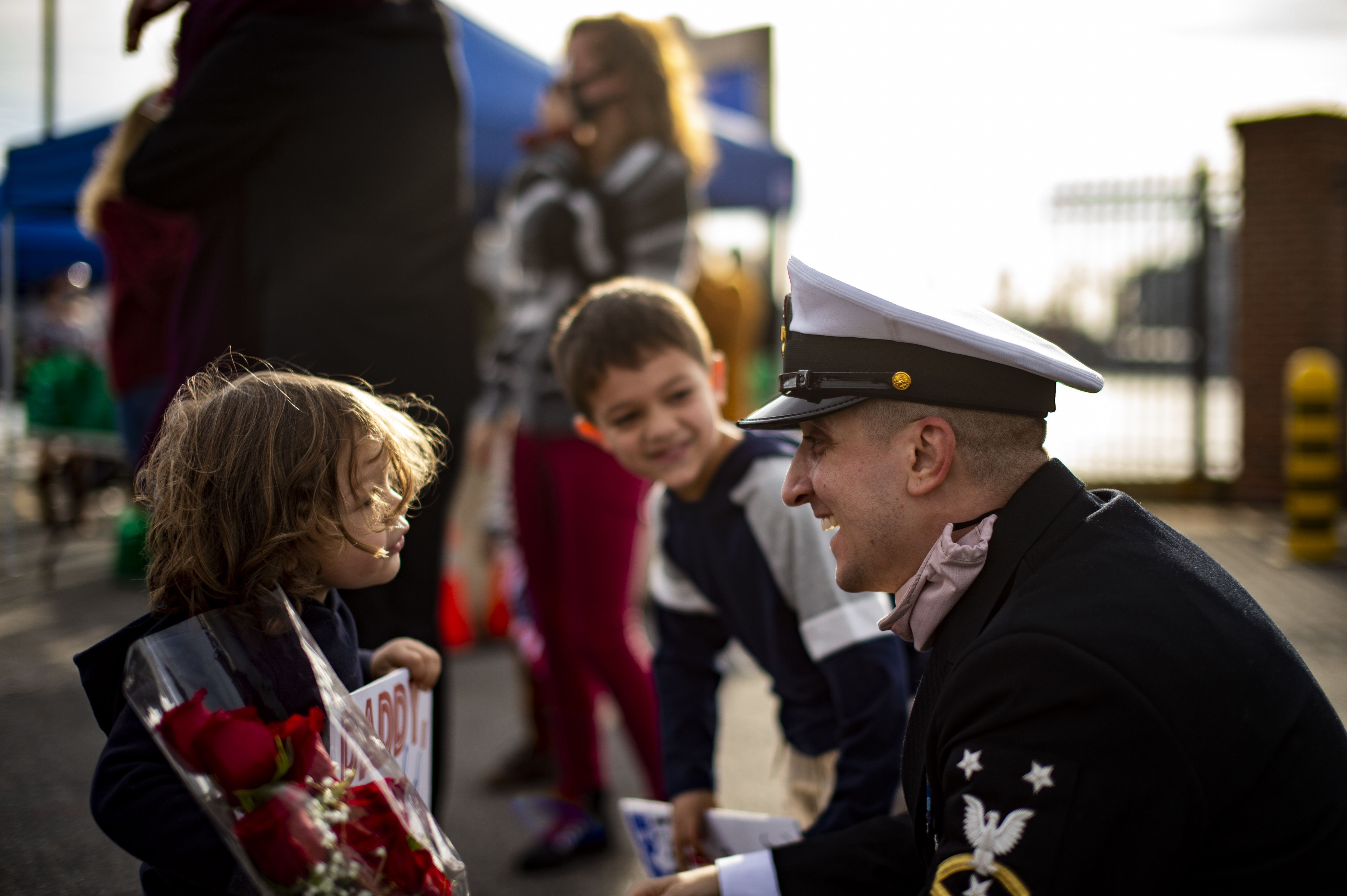 Command Master Chief Anthony Amato, the chief of the boat assigned to the Virginia-class fast-attack submarine USS John Warner (SSN 785), greets his sons during the boat’s homecoming at Naval Station Norfolk, Nov. 25, 2020.