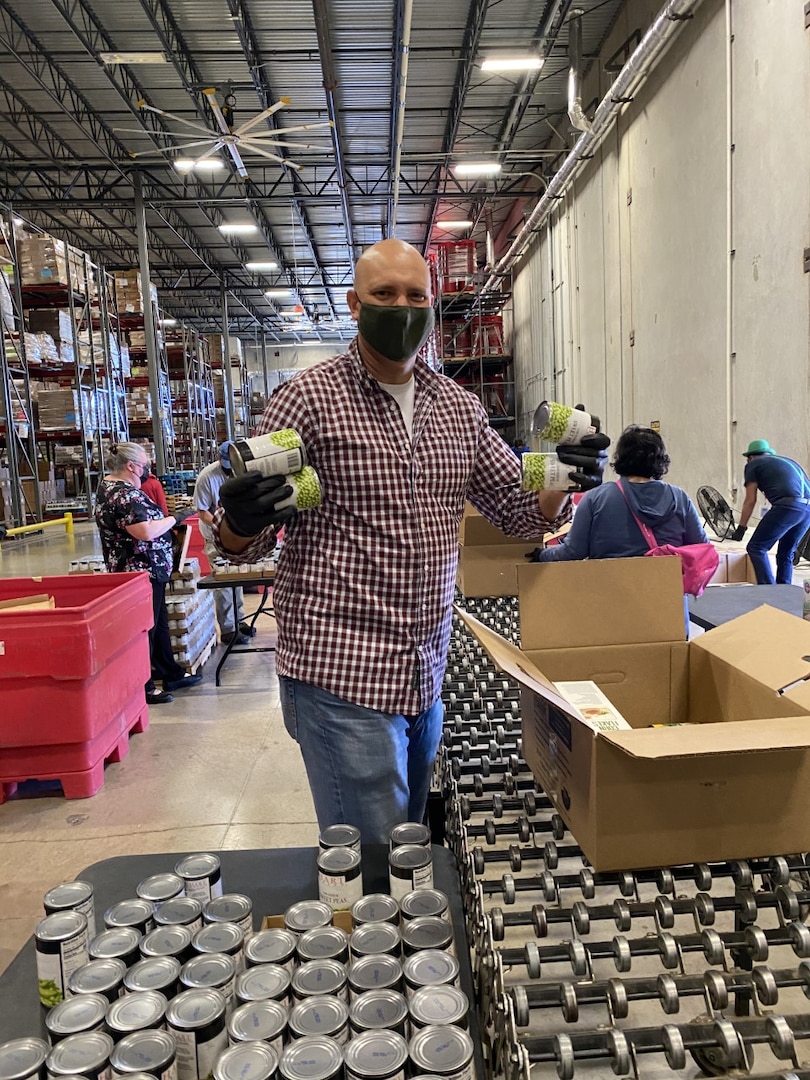 Jeff Whittaker, NSA-Texas E&P deputy director, packages cans of food.