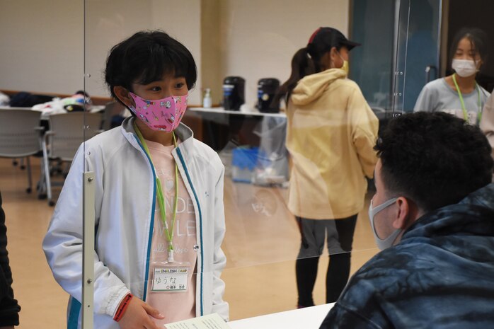 A U.S. Marine talks with a child during an English activity at the National Chuo Youth Friendship Center’s fourth annual English camp Nov. 21 to Nov. 22.