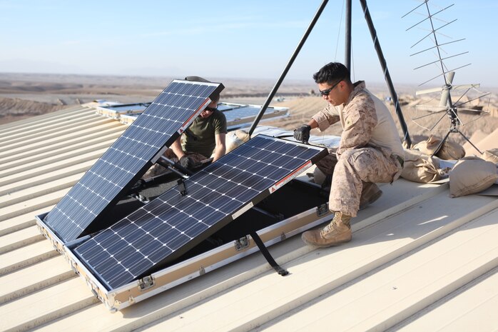 U.S. Marine Corps Cpl. Robert G. Sutton, left, and Cpl. Moses E. Perez, field wireman with Combat Logistics Regiment 15 install new solar panels on Combat Outpost Shukvani, Helmand province, Afghanistan, Nov. 19, 2012.