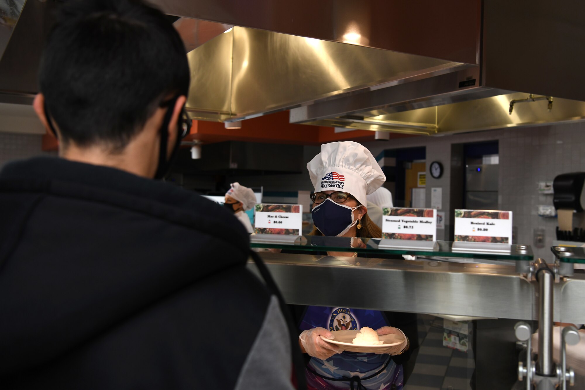 Gina Carbajal, Rep. Salud Carbajal's wife, serves Thanksgiving meals to service members at the Breakers Dining Facility Nov. 26, 2020, at Vandenberg Air Force Base, Calif.