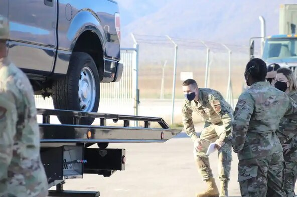 Image of an Airman looking at a vehicle