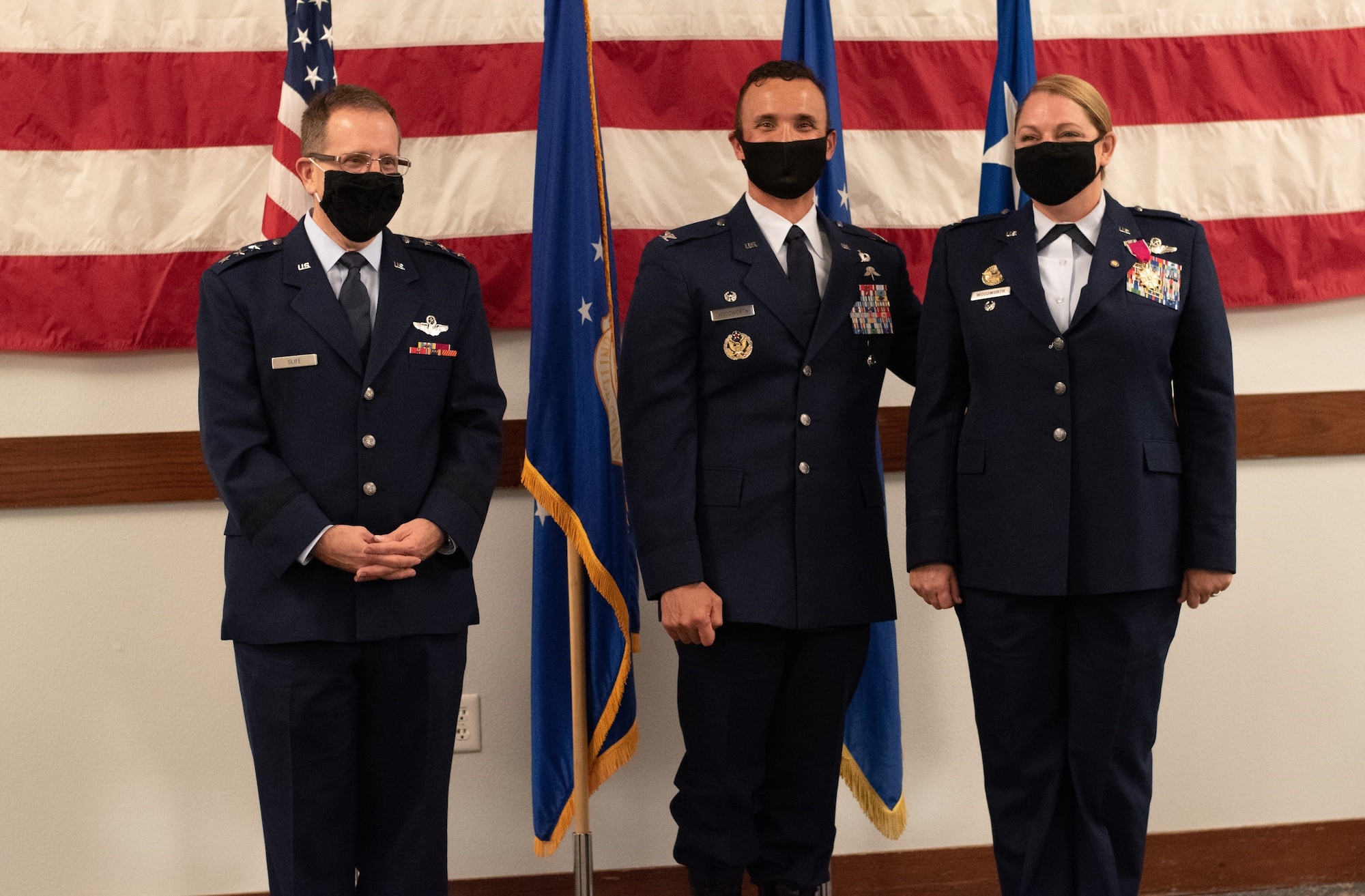 U.S. Air Force Col. Shelley Woodworth, right, stands with her husband U.S. Air Force Col. Travis Woodworth, center, and U.S. Air Force Lt. Gen. Jim Slife, Air Force Special Operations Commander, during her retirement ceremony on Nov. 24, 2020.