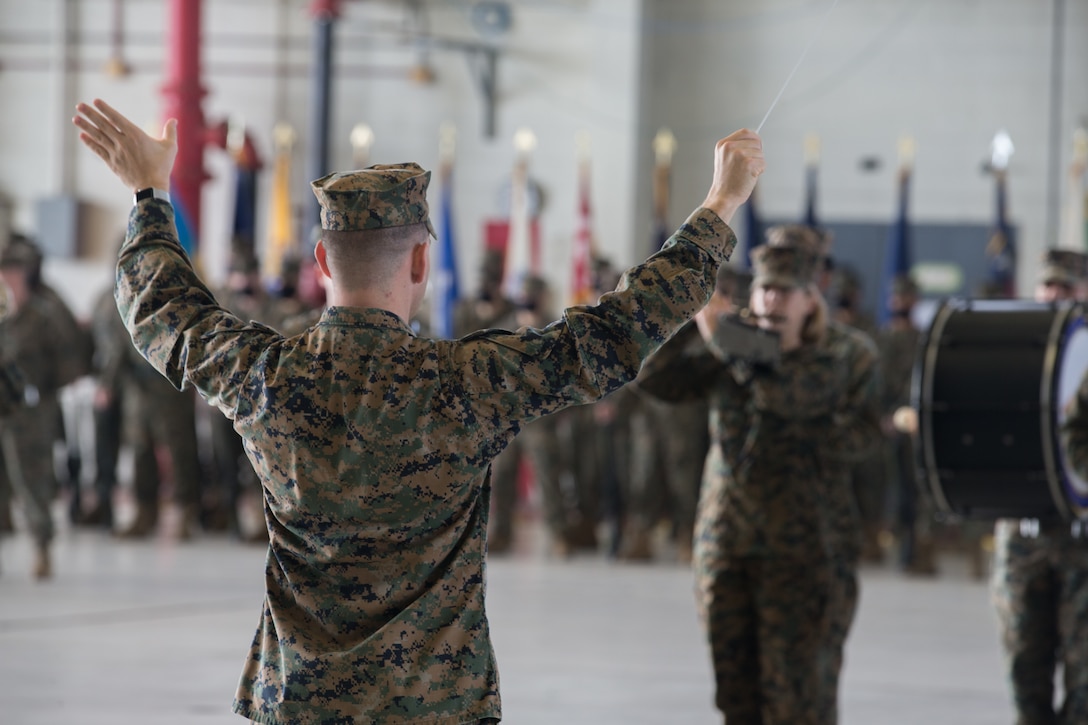 A conductor directs the playing of the 2nd Marine Aircraft Wing band during a relief and appointment ceremony at Marine Corps Air Station Cherry Point (MCAS), North Carolina, Nov. 6, 2020. The ceremony was held to transition the position of Headquarters and Headquarters Squadron sergeant major from Sgt. Maj. Thomas J. Korabik Jr., to Sgt. Maj. James I. Petty. (U.S. Marine Corps photo by Lance Cpl. Jacob Bertram)
