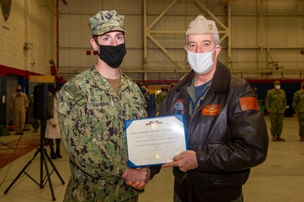 Rear Adm. John Meier, Commander, Naval Air Force Atlantic, awards Naval Helicopter Aircrewmen 1st Class George Parsons III, assigned to Helicopter Sea Combat Squadron (HSC) 9 the Navy and Marine Corps medal