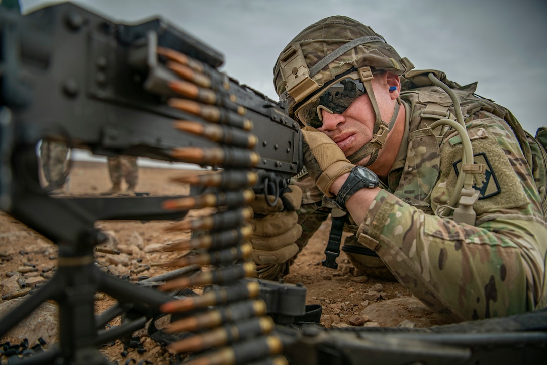 A soldier fires a weapon.