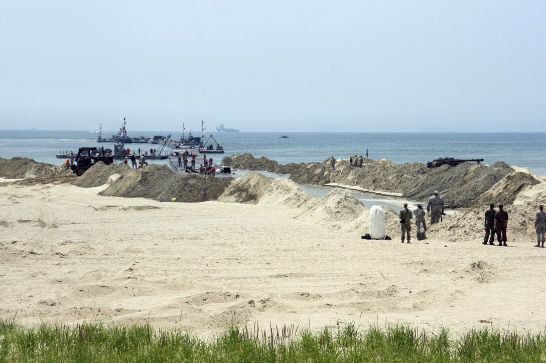 331st Transportation Company (Modular Causeway System) inserts a Trident Pier into Anmyeon Beach on the west coast of the Republic of Korea during exercise Combined Joint Logistics Over the Shore (LOTS) 2015.  LOTS are military activities that include offshore loading and unloading of ships when fixed port facilities are unavailable or denied due to enemy activities.