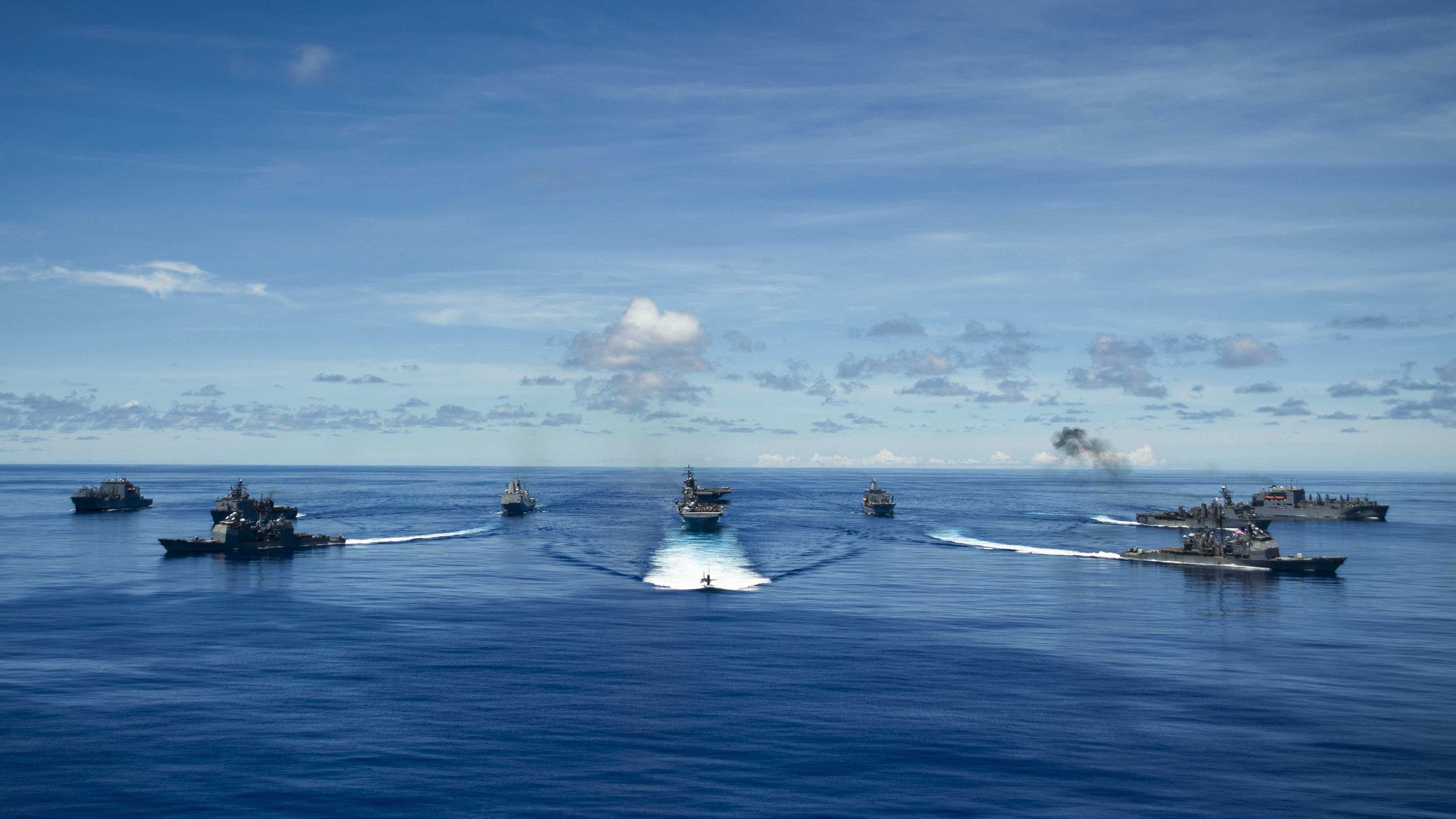 fleets in formation sailing over blue ocean