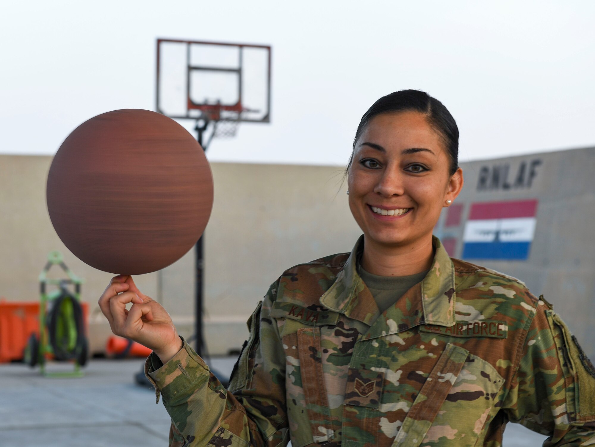 U.S. Air Force Staff Sgt. Cinnamon Kava, 5th Expeditionary Air Mobility Squadron combat oriented support operations supply specialist, spins a basketball on her fingertips at Ali Al Salem Air Base, Kuwait, Nov. 19, 2020.