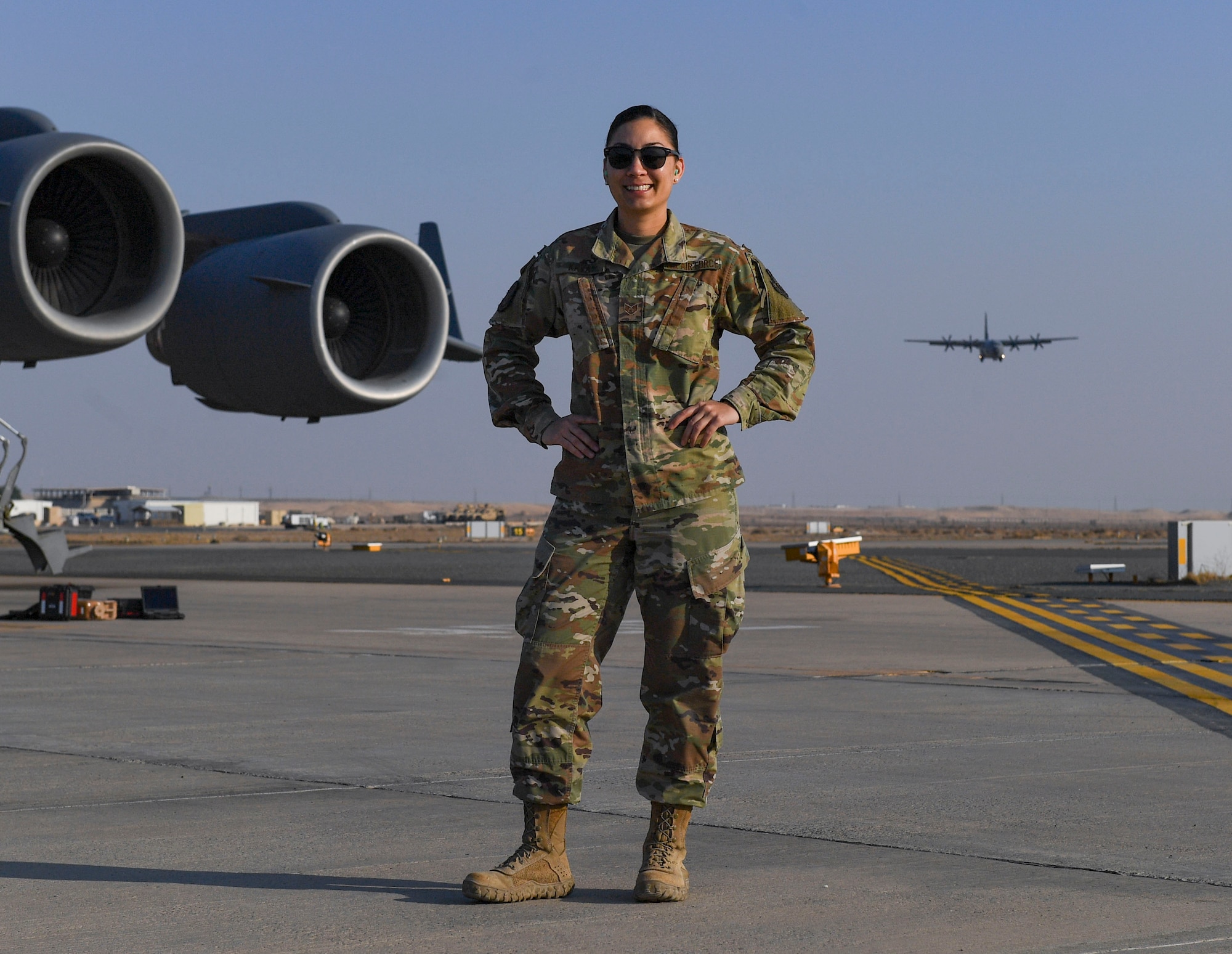 U.S. Air Force Staff Sgt. Cinnamon Kava, 5th Expeditionary Air Mobility Squadron combat oriented support operations supply specialist, poses on the runway at Ali Al Salem Air Base, Kuwait, Nov. 18, 2020.