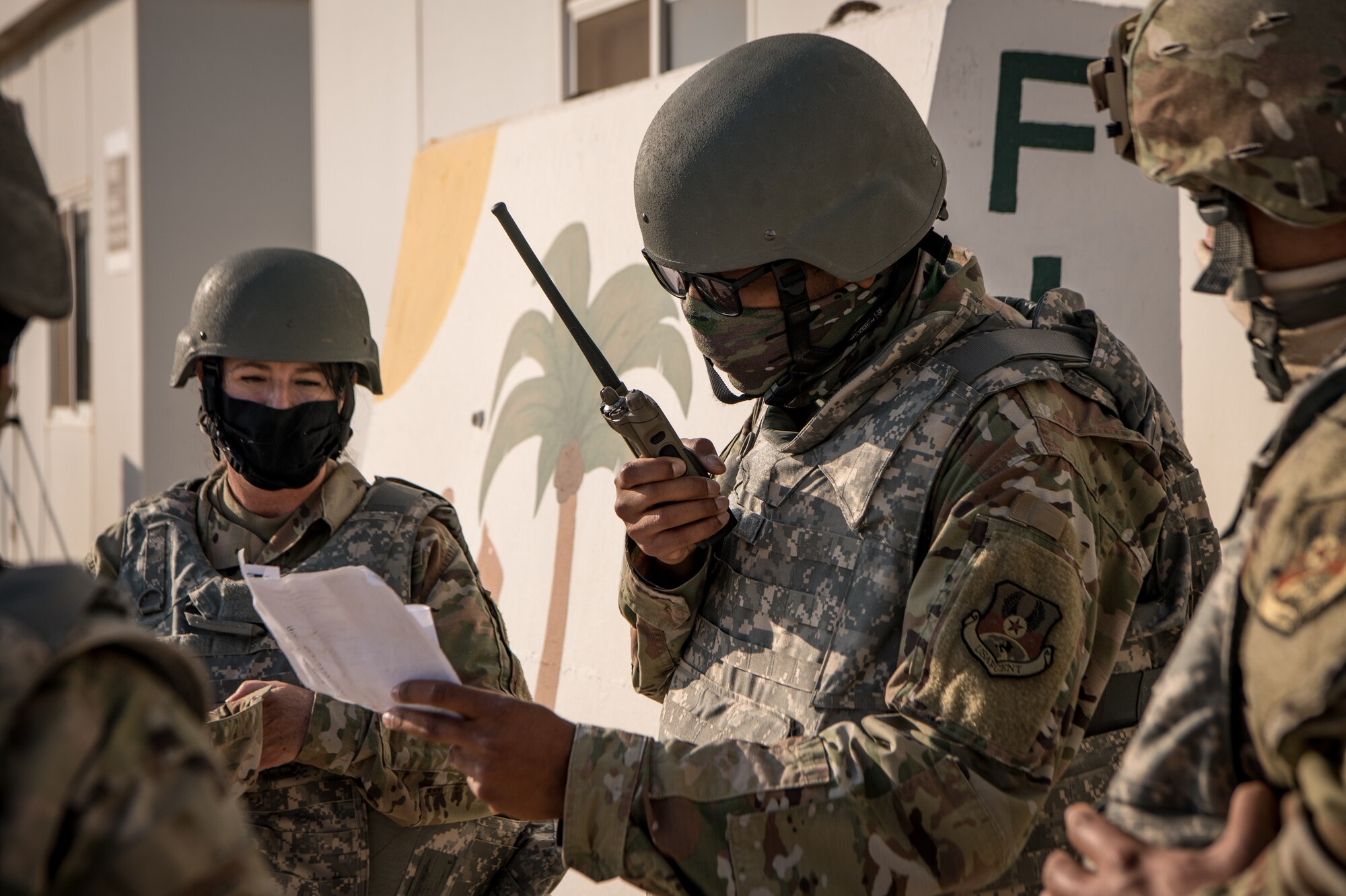 An Airman communicates on a handheld radio