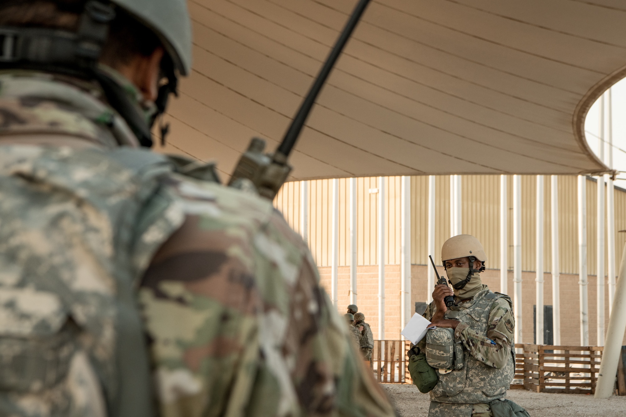 Airmen communicate through handheld radios