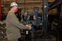 Charles Rodgers, a welder in Norfolk Naval Shipyard’s Structural Production Resources, Code 920, operates the Advanced Manufacturing Engineering Technologies (AMET) Welding and Cladding System. The system is used to manufacture joints, repair and extend the lifespan of large valves, and service various other shipboard components.
