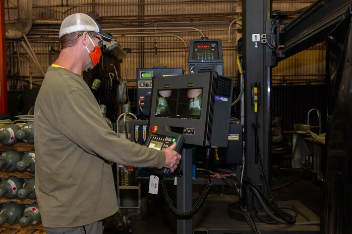 Charles Rodgers, a welder in Norfolk Naval Shipyard’s Structural Production Resources, Code 920, operates the Advanced Manufacturing Engineering Technologies (AMET) Welding and Cladding System. The system is used to manufacture joints, repair and extend the lifespan of large valves, and service various other shipboard components.