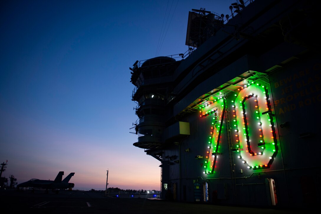 The number '70' is lit up in green on the side of a ship.