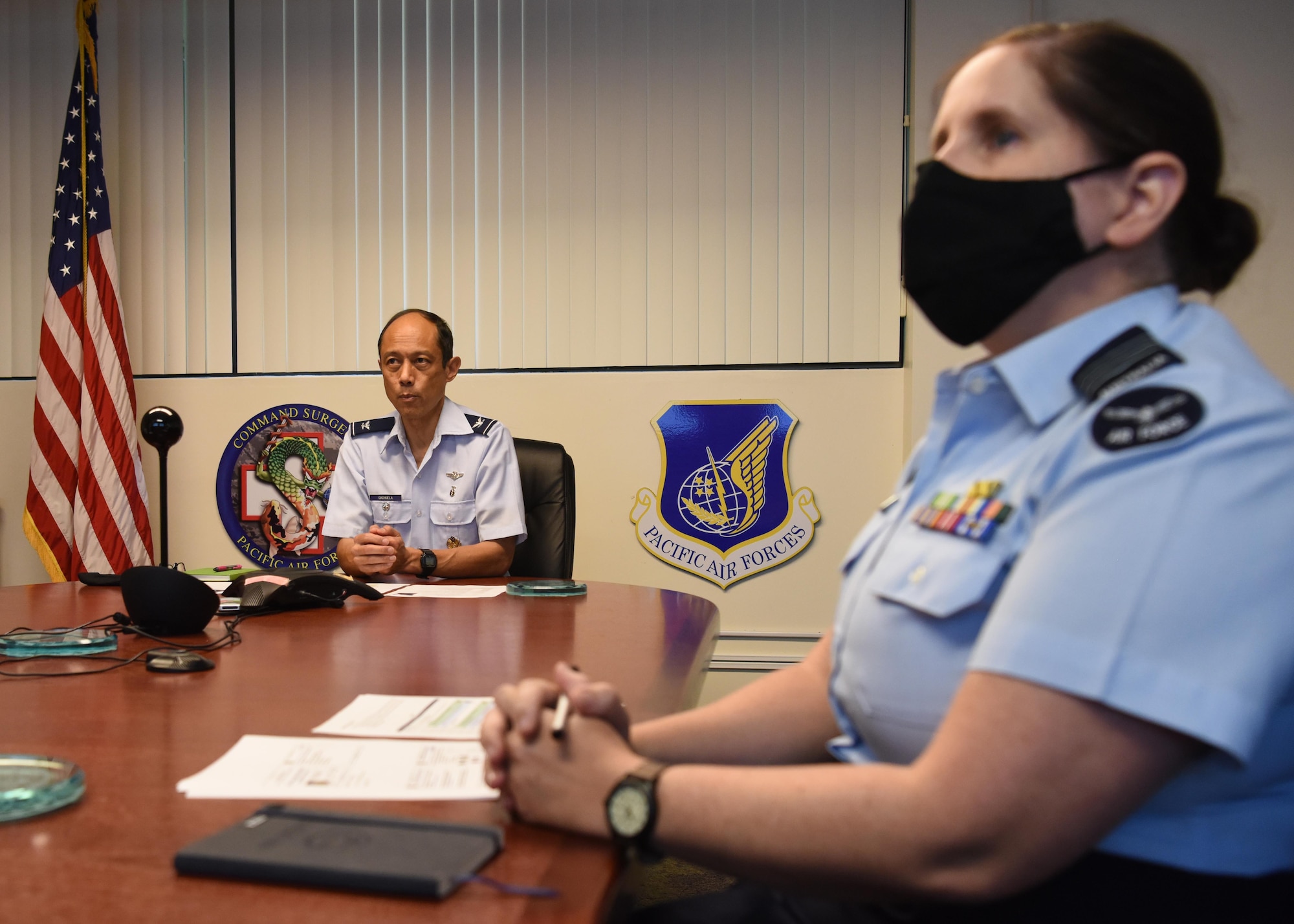 U.S. Air Force Col. Rudy Cachuela, left, Pacific Air Forces command surgeon, provides opening remarks, as Royal Australian Air Force (RAAF) WGCDR Joleen Darby, Australian Exchange Senior Flight Surgeon, PACAF/SG looks on, during an Aerospace Medicine virtual knowledge exchange with medical experts from the Royal Australian Air Force and Royal Thai Air Force, at Joint Base Pearl Harbor-Hickam, Hawaii, Nov. 23, 2020.  The exchange focused on highlighting current best practices in aviation medicine and patient movement to enhance aircrew safety and patient care.  (U.S. Air Force photo by Tech. Sgt. Zach Vaughn)