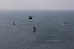 ARABIAN GULF (Nov. 11, 2020) Royal Saudi Naval Force mine countermeasures vessel Shaqra (422), left, mine countermeasure ship USS Dextrous (MCM 13), middle, Royal Navy mine countermeasures vessel HMS Brocklesby (M 33) and a MH-53E Sea Dragon helicopter, attached to Helicopter Mine Countermeasures Squadron 15, sail in formation during mine countermeasures interoperability training, led by Commander, Task Force (CTF) 52 in the Arabian Gulf, Nov. 11. CTF 52 provides command and control of all mine warfare assets in the U.S. 5th Fleet area of operations. The 5th Fleet area of operations encompasses about 2.5 million square miles of water area and includes the Arabian Gulf, Arabian Sea, Gulf of Oman, Red Sea and parts of the Indian Ocean. The expanse is comprised of 20 countries and includes three critical choke points at the Strait of Hormuz, the Suez Canal and the Bab el-Mandeb Strait at the southern tip of Yemen. (U.S Army photo by Spc. William Gore)