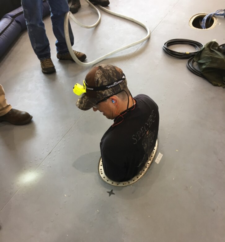 A maintainer uses the Confined Space Monitoring System in the wing of a C-17 aircraft. The Air Force Research Laboratory partnered with Dayton, Ohio-based small business Sentinel Occupational Safety Inc., to refine and market this technology as an added layer of safety for maintenance crews. (U.S. Air Force photo/Jennifer Tribble)