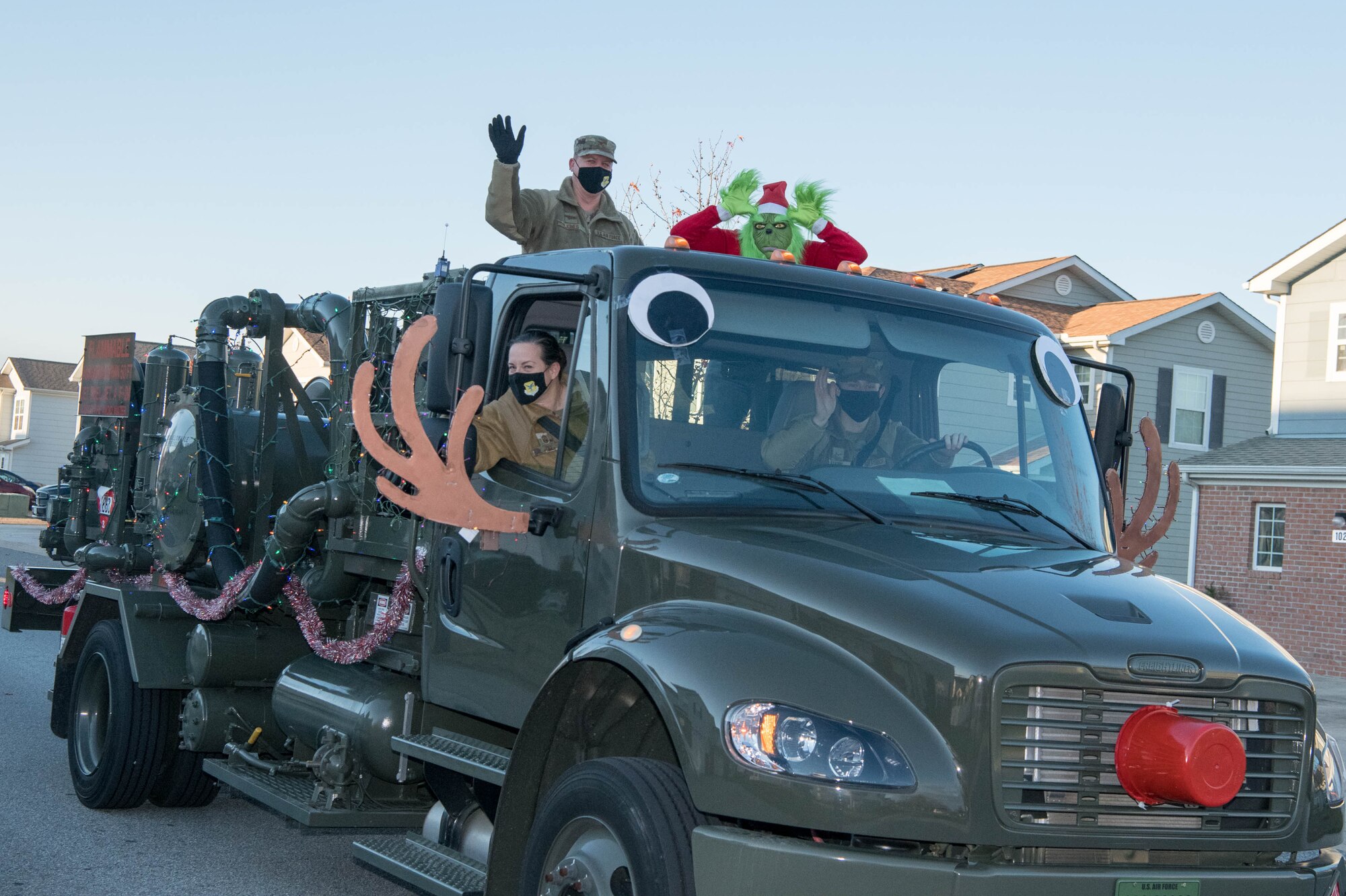 Col. Matthew Jones, 436th Airlift Wing commander and Chief Master Sgt. Shae Gee, 436th AW command chief, wave to spectators during the Holiday Parade Dec. 1, 2020, at Dover Air Force Base, Delaware. The event was followed by a Christmas concert and Christmas tree lighting ceremony. (U.S. Air Force photo by Mauricio Campino)