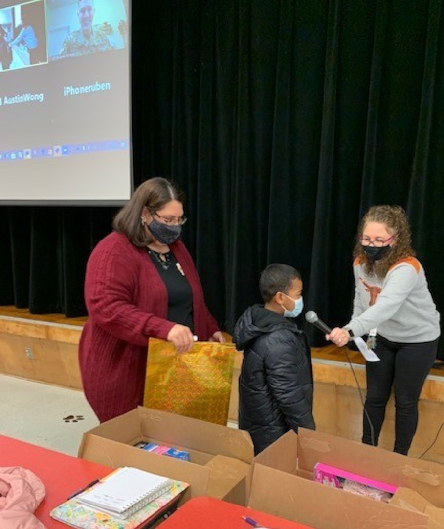 A student at Wilshire Elementary School thanks service members during a virtual ceremony Nov. 30, 2020. Volunteers from the 502nd Force Support Group and the 106th Signal Brigade at Joint Base San Antonio-Fort Sam Houston donated 36 coats and other gifts to students at the school.
