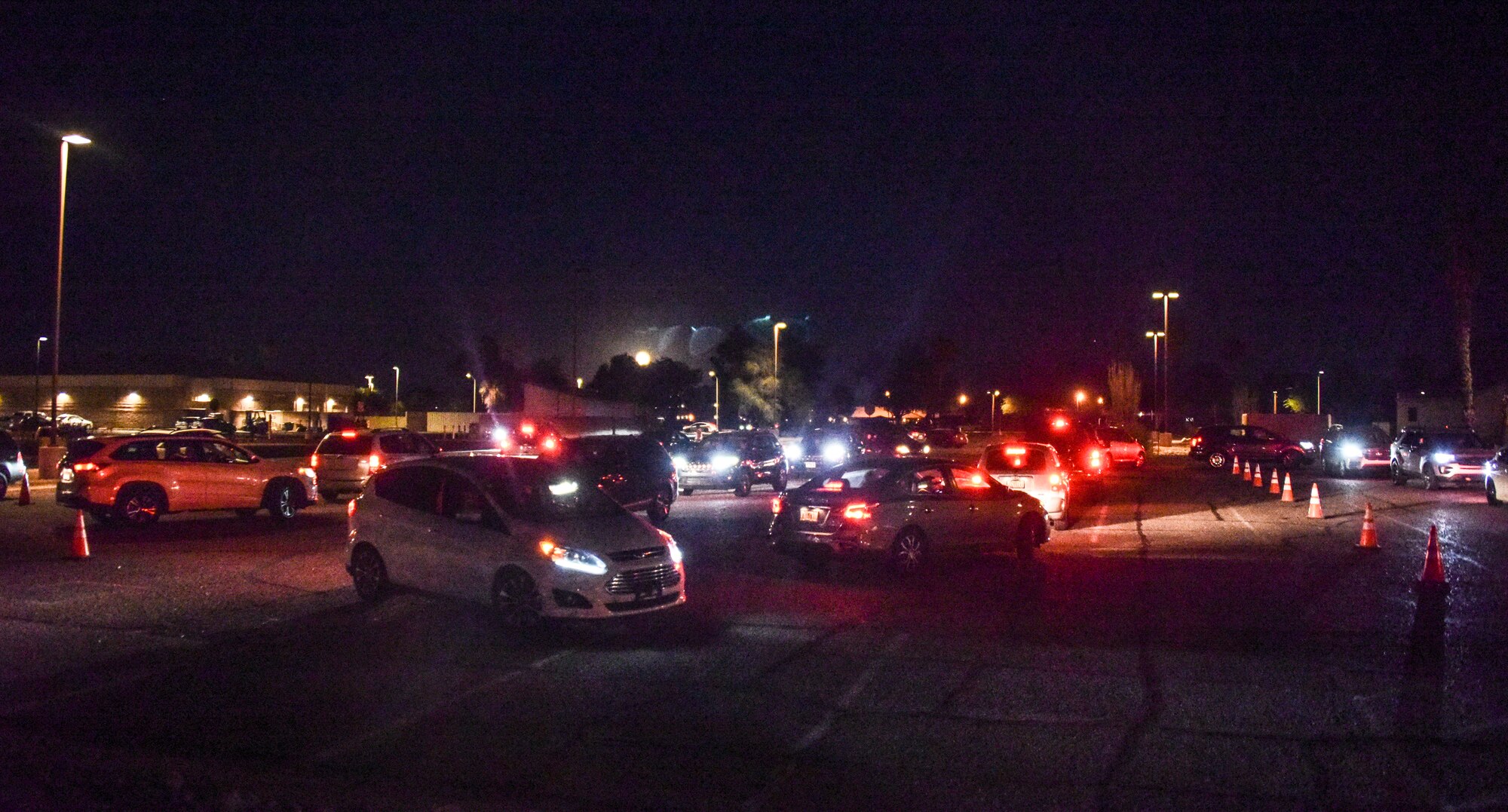 A line of cars are waiting for their turn to meet Santa.
