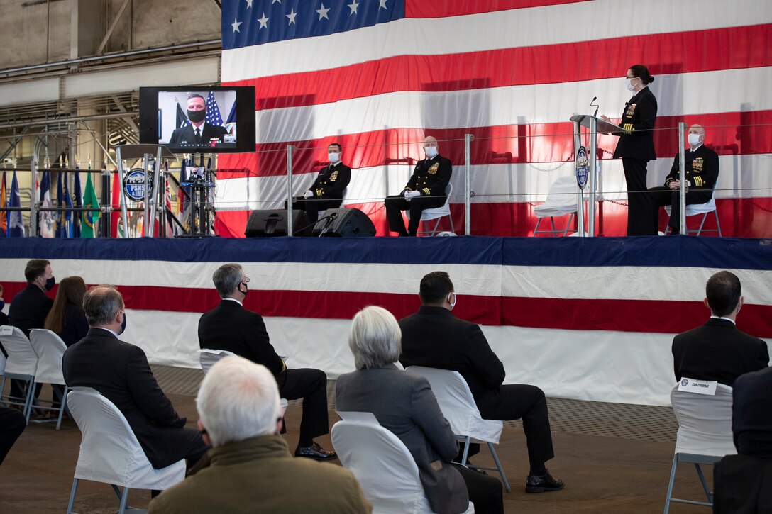 Puget Sound Naval Shipyard & Intermediate Maintenance Facility welcomed its new commander Dec. 2, 2020, at the shipyard in Bremerton, Washington, during a unique change of command ceremony that was arranged to protect participants and audience members from COVID-19. Capt. Jip Mosman relieved Capt. Dianna Wolfson during the ceremony in the historic Building 460. Vice Adm. William J. Galinis, commander, Naval Sea Systems Command, participated in the event via teleconference from NAVSEA headquarters in Washington, D.C. (PSNS & IMF photo by Wendy Hallmark)