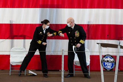 Puget Sound Naval Shipyard & Intermediate Maintenance Facility welcomed its new commander Dec. 2, 2020, at the shipyard in Bremerton, Washington, during a unique change of command ceremony that was arranged to protect participants and audience members from COVID-19. Capt. Jip Mosman relieved Capt. Dianna Wolfson during the ceremony in the historic Building 460. Vice Adm. William J. Galinis, commander, Naval Sea Systems Command, participated in the event via teleconference from NAVSEA headquarters in Washington, D.C. (PSNS & IMF photo by Carie Hagins)