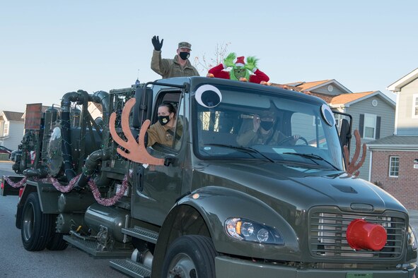 Col. Matthew Jones, 436th Airlift Wing commander and Chief Master Sgt. Shae Gee, 436th AW command chief, wave to spectators during the Holiday Parade Dec. 1, 2020, at Dover Air Force Base, Delaware. The event was followed by a Christmas concert and Christmas tree lighting ceremony. (U.S. Air Force photo by Mauricio Campino)