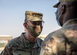 U.S. Army Lt. Gen. Terry Ferrell, commanding general at U.S. Army Central, shares a smile with the U.S. Army Col. James O. Oyekan, command surgeon at Area Support Group - Kuwait, during a coin ceremony on Camp Arifjan, Kuwait, November 18, 2020. Ferrell recognized the exemplary leadership of Oyekan and the medical team at ASG-KU in combating COVID-19 on U.S. Army bases within Kuwait. (U.S. Army Reserve photo by Sgt. Khylee Woodford)