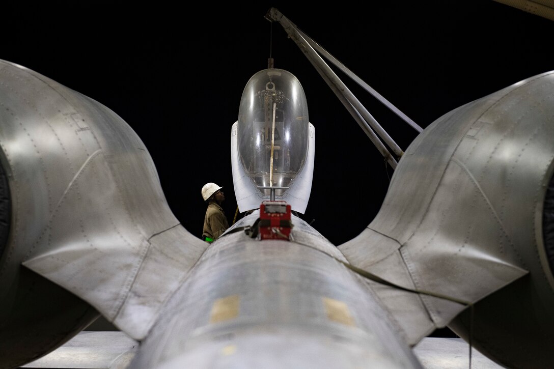 Senior Airman Zachary Cook, 51st Maintenance Squadron Egress systems specialist, helps direct an ejection seat onto an A-10 Thunderbolt II at Osan Air Base, Republic of Korea, Dec. 2, 2020. The Air Force Egress career field’s motto “We punch pilots out!” refers to the pilot’s ejection sequence during an in-flight emergency. (U.S. Air Force photo by Senior Airman Greg Nash)