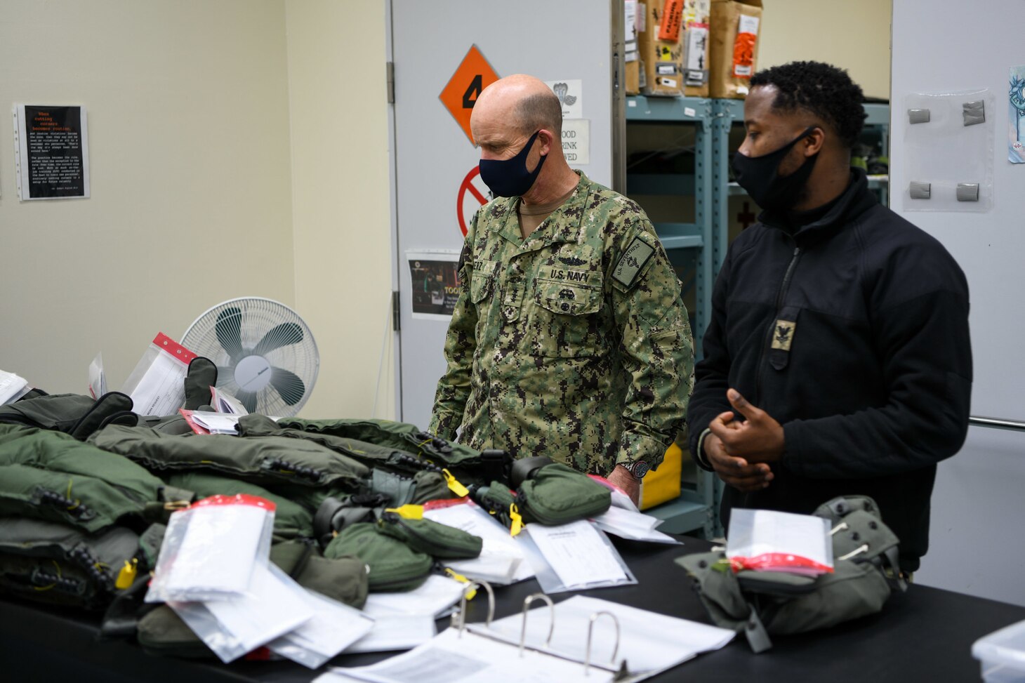 MISAWA, Japan (Dec. 2, 2020) – Aircrew Survival Equipmentman 2nd Class Ernso Sanon, right, assigned to Aviation Intermediate Maintenance Detachment (AIMD) Misawa, shows Vice Adm. Bill Merz, Commander, U.S. 7th Fleet, his work environment at the paraloft during a visit to Naval Air Facility (NAF) Misawa. Merz is conducting fleet circulation visits to NAF Atsugi and NAF Misawa with a focus on discussing the U.S. 7th Fleet Warfighting Concepts and engagement with tenant commands and rotational deployers. U.S. 7th Fleet conducts forward-deployed naval operations in support of U.S. national interests in the Indo-Pacific area of operations. As the U.S. Navy's largest numbered fleet, 7th Fleet interacts with 35 other maritime nations to build partnerships that foster maritime security, promote stability, and prevent conflict.