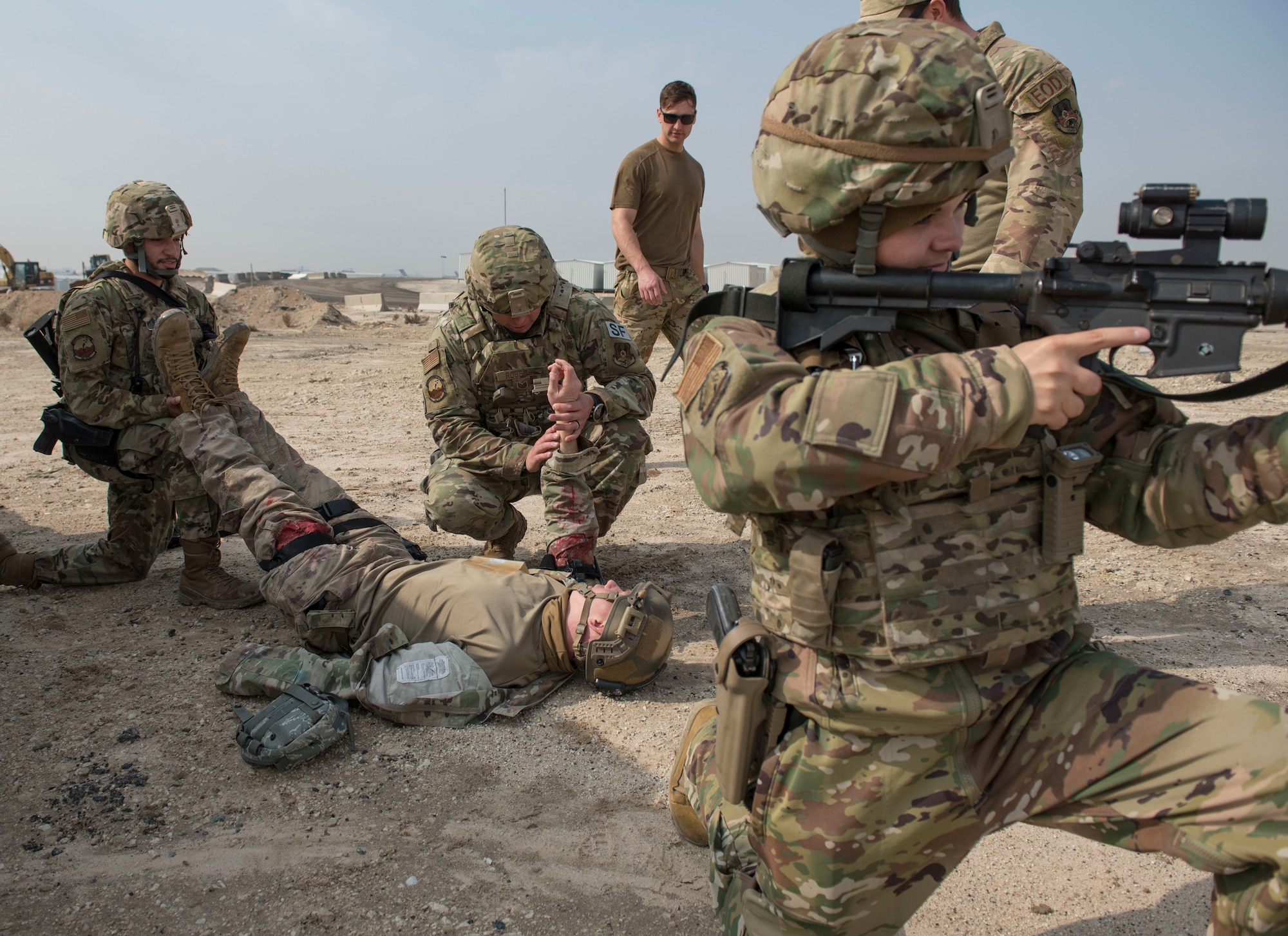 U.S. Air Force Airmen assigned to the 386th Expeditionary Security Forces Squadron work together to provide aid to a mock victim during an improvised explosive device and unexploded ordnance familiarization course at Ali Al Salem Air Base, Kuwait, Dec. 2, 2020.