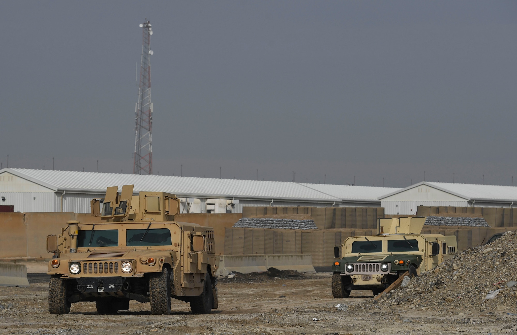 U.S. Air Force Airmen assigned to the 386th Expeditionary Security Forces Squadron drive Humvees while searching for roadside devices during an improvised explosive device and unexploded ordnance familiarization course at Ali Al Salem Air Base, Kuwait, Dec. 2, 2020.