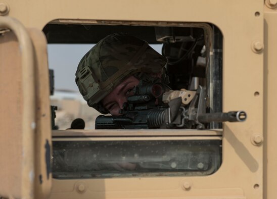 U.S. Air Force Senior Airman Rosealine McDonald, 386th Expeditionary Security Forces Squadron response force member, monitors the area during an improvised explosive device and unexploded ordnance familiarization course at Ali Al Salem Air Base, Kuwait, Dec. 2, 2020.